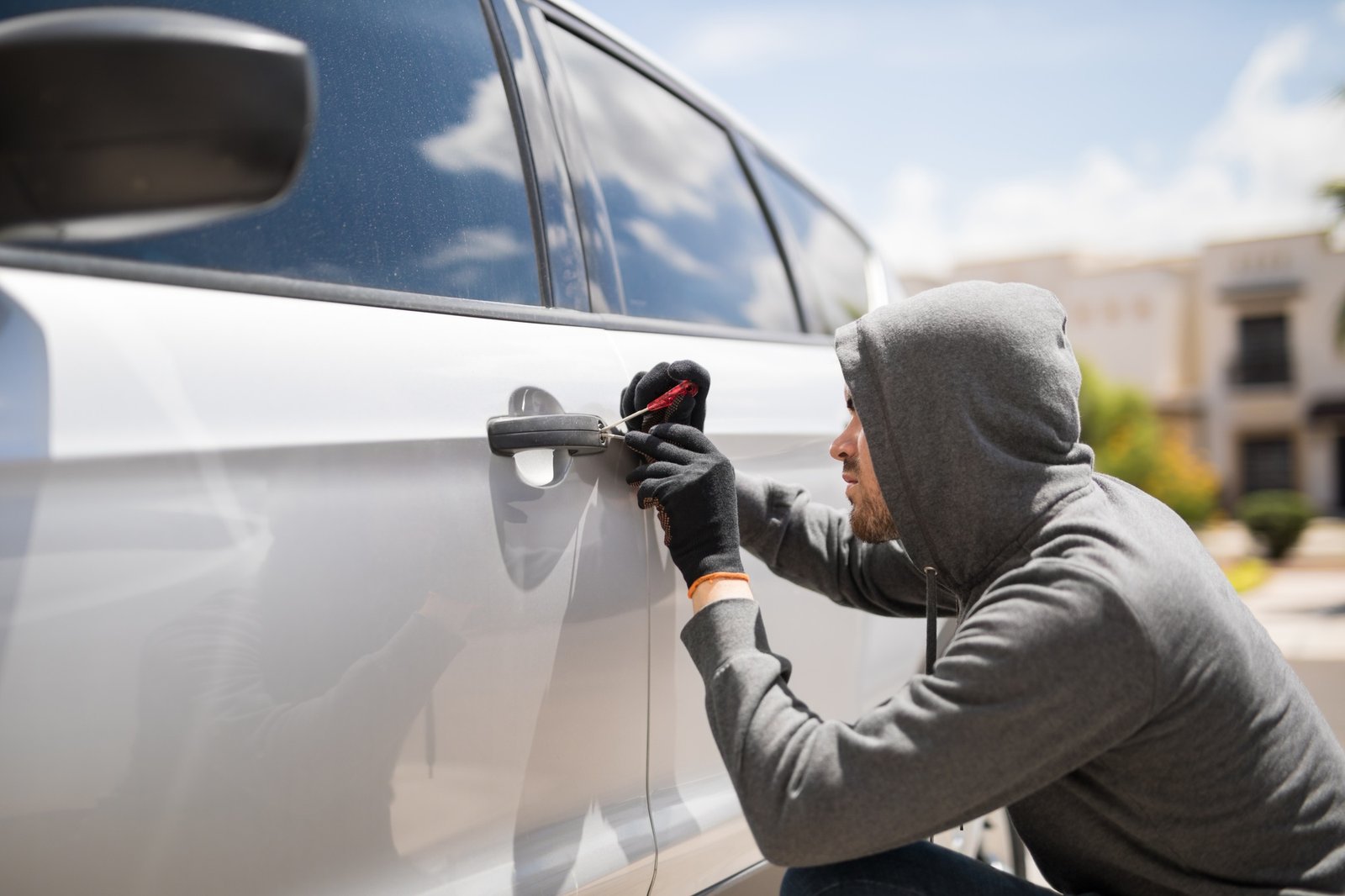 Forcing entry and stealing a car